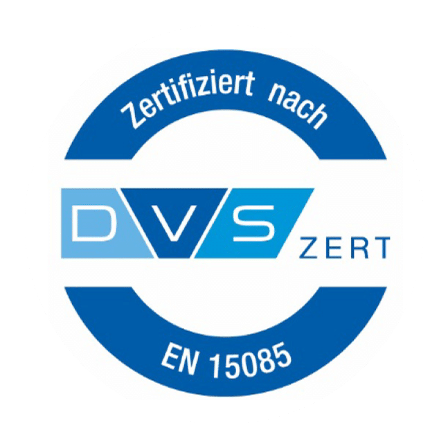 Kreisförmiges Logo mit blauen und weißen Farben, mit dem Text "Zertifiziert nach DVS ZERT EN 15085" um und innerhalb des Kreises, der auf die Zertifizierung nach der Norm EN 15085 für Maschinenbauteile hinweist.